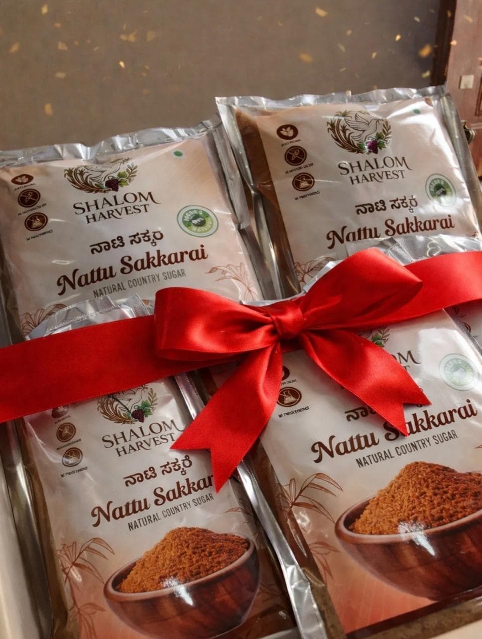 Shalom Harvest Nattu Sakkarai gift pack, tied with a red ribbon